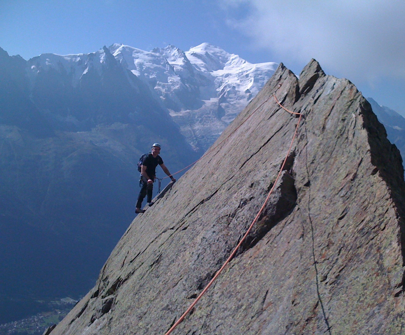 Climber standing on mountain with view of Mont Blanc